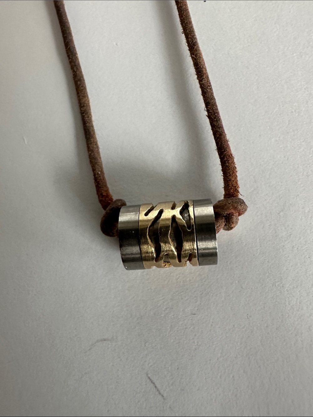 Pandora (maybe) titanium and gold bead on leather cord necklace.